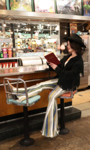 girl reading a book with cowboy hat inside a vintage store Rodeo Outfits (with boots)