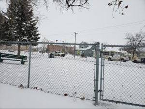 Photo of Triangle Park, a beloved little park located in Miles City, MT, which is surrounded by a Chain-Link fence other side